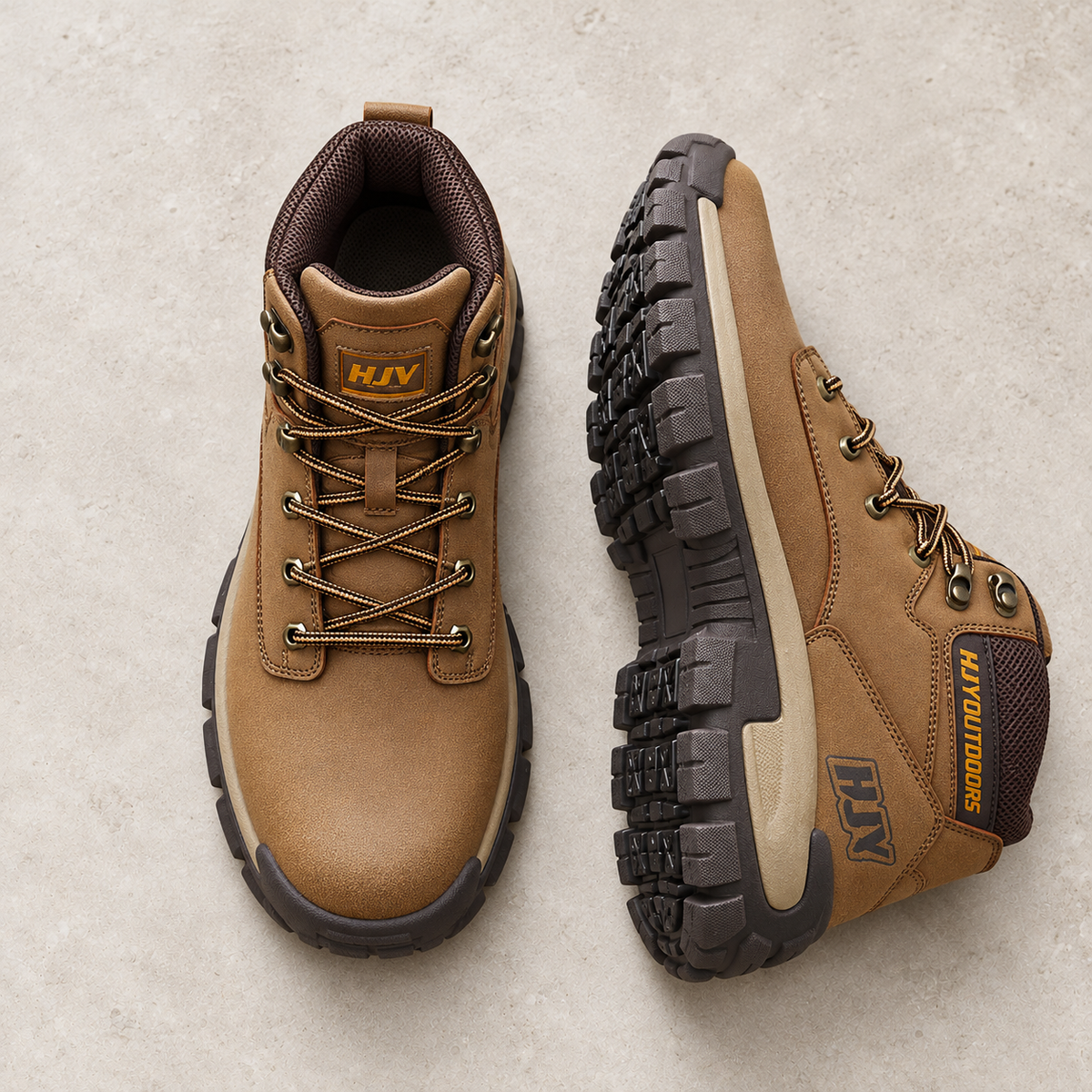 A pair of brown outdoor hiking boots on pale limestone, showing the upper and rugged outsole.
